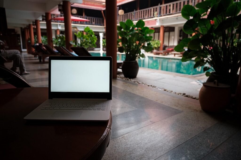 A White Laptop On Wooden Table Swiming Pool Backgr 2022 07 04 13 35 12 Utc.jpg
